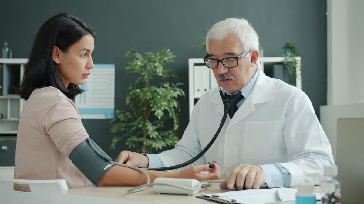 A nurse taking a blood pressure reading at a community screening